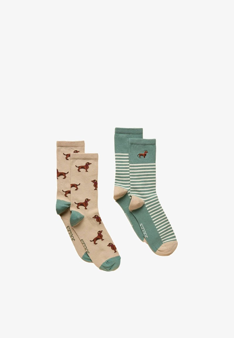 Deux paires de chaussettes : une beige avec un motif de chien marron et des orteils bleu sarcelle, l'autre bleu sarcelle avec des rayures blanches et un petit chien marron près du bord-côte.