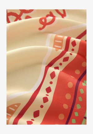 Printed fabric featuring a cream base with colorful patterns of red, orange, and green. Texture appears smooth and slightly glossy.