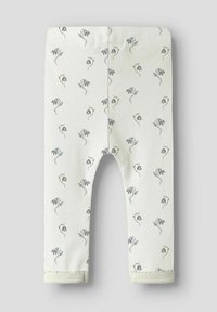 Licht crèmekleurige legging met een bloemenpatroon, voorzien van kleine blauwe bloemen en groene stengels. Zacht katoenen materiaal met een elastische tailleband.