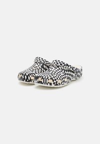 Black and white checkered clogs made of synthetic material, featuring a rounded toe, curved edges, and a textured surface.