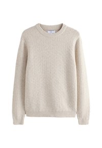 Ljusbeige texturerad tröja med rund halsringning och ribbade muddar, med ett quiltat mönster över hela kroppen.