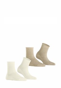 Twee paar enkelkousen in lichtbeige en crème. Textuurpatronen bedekken de stof, met ribbels aan de boorden en gladde zolen.
