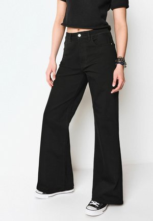 STANDARD - Flared Jeans - black