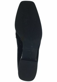 Black leather shoe sole with a textured surface, featuring a low heel and embossed brand name 'HASSIA.' Smooth finish with no visible patterns.