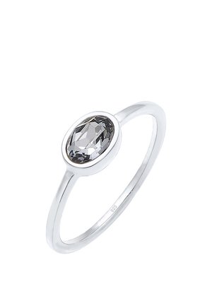 Silver ring with a sleek band featuring an oval, faceted gray gemstone set in a bezel setting.