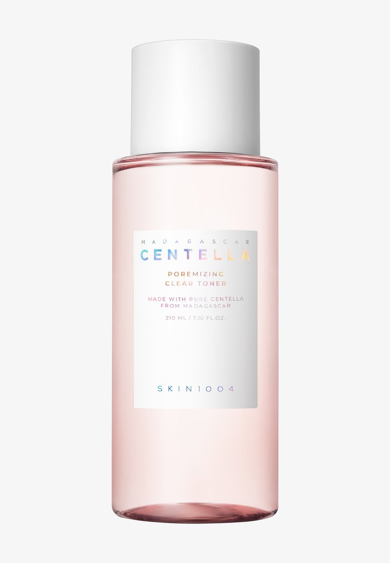 Przezroczysta różowa butelka toniku z białą zakrętką. Etykieta zawiera wielokolorowy tekst; nazwa produktu, objętość i składniki są wyraźnie widoczne.