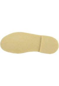 Semelle de chaussure beige avec une texture lisse, une forme légèrement contournée et une zone de orteils arrondie. Aucun motif ou détail matériel visible.