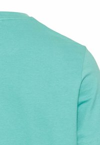 Turkis bomulds T-shirt med rund hals, korte ærmer og glat tekstur. Ingen synlige mønstre eller hardware-detaljer.