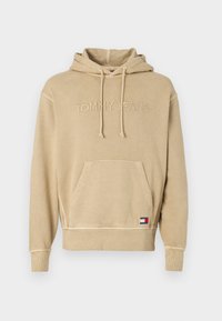 Felpa beige realizzata in tessuto morbido, con logo ricamato, tasca frontale, cappuccio con coulisse e polsini e fondo a coste.