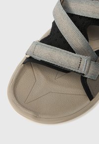 Γκρι και μαύρα σανδάλια με ρυθμιζόμενους ιμάντες, υφή από καουτσούκ στη σόλα με σχέδιο αστεριού και ανθεκτικό αεριζόμ ενο ανώτερο υλικό.