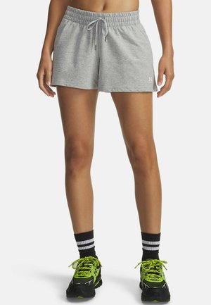 Gray athletic shorts with an elastic waistband and drawstring. Worn with black and neon green sneakers and striped crew socks.