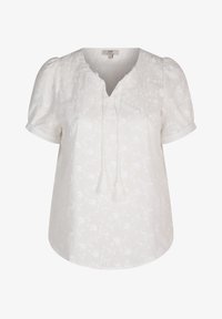 Witte geborduurde blouse met een V-halslijn, korte pofmouwen en striksluiting met kwastjes. Bloemmotief verspreid over de blouse. Zachte textuur.