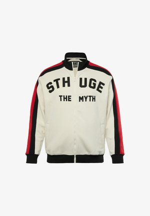 Bílá zipovací bunda s textem "STHUGE THE MYTH" v černém písmu. Obsahuje rukávy s červeno-černými pruhy, žebrované manžety a stojáček.