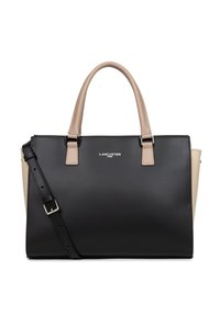 Sac fourre-tout noir et beige en matériau synthétique, forme structurée, doubles poignées supérieures, bandoulière amovible et affichage décoratif du logo.