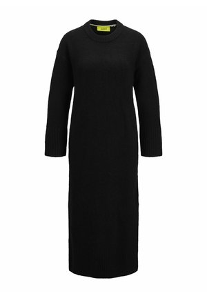 Robe en tricot noire avec un col rond, des manches longues et des poignets côtelés. Silhouette longue et droite avec une finition texturée.