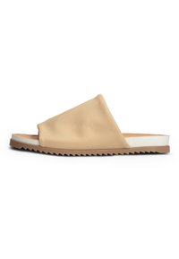 Beige leather slide sandal with an asymmetrical design, white midsole, and zigzag patterned outsole for added grip and style.