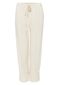 Pantalons de lounge en tissu côtelé beige clair, dotés d'une taille élastique et d'un cordon de serrage. Les ourlets ajustés offrent une coupe décontractée.