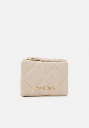Beige quilted leather wallet with gold hardware and a zip closure. Features a sleek rectangular shape and an embossed brand logo on the front.