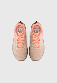 Beige running shoes with a textured mesh upper, orange accents, and reflective detailing. Features laces and a cushioned sole.