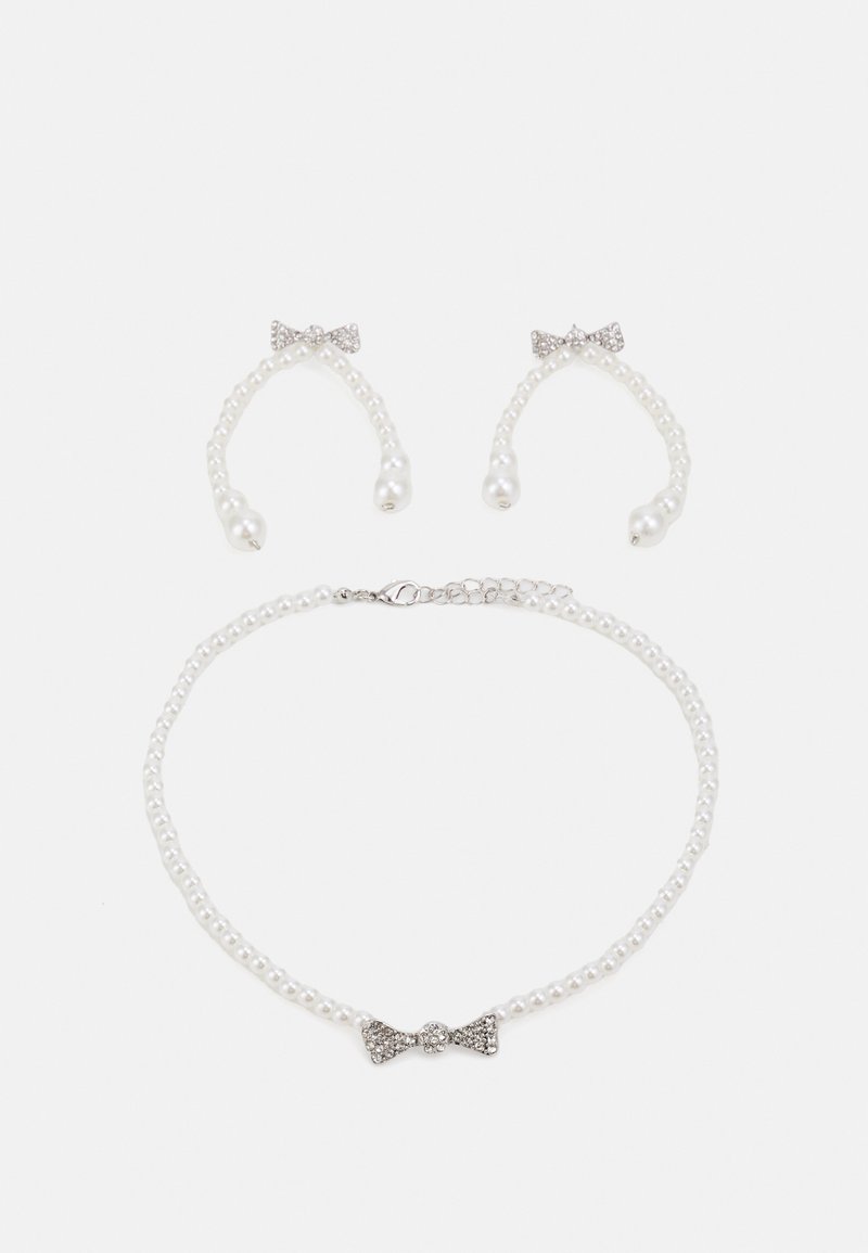 Pearl necklace and matching earrings set. Necklace features round pearls with a silver bow accent; earrings mimic bow design with pearl dangles.