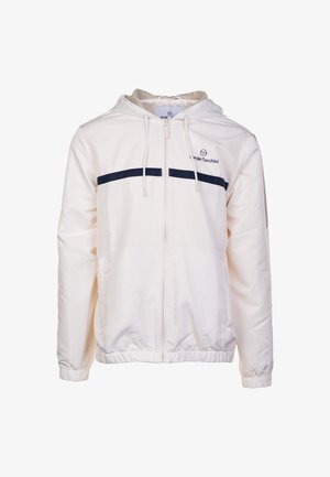 Weißer Reißverschlussjacke mit Kapuze, versehen mit marineblauen horizontalen Streifen über der Brust und elastischen Bündchen. Hergestellt aus leichtem Stoff.