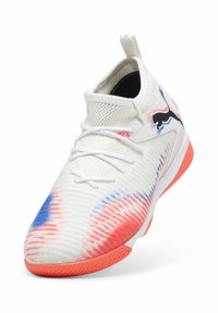 Baskets blanches avec des accents corail et bleu, tige en maille, tirette, lacets et un logo Puma noir sur le côté.