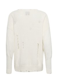 Pull en maille blanche à coupe ample, manches longues, avec de petits trous délibérément usés répartis sur tout le tissu.