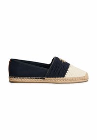 Slip-on espadrille with navy and off-white crochet upper, tan braided jute sole, and small gold emblem on top.