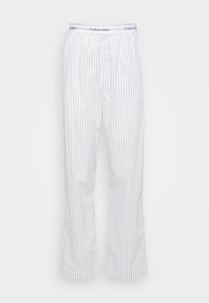 Calvin Klein hvite pysjamasbukser med smale blå striper. Har elastisk midje med logo, rett benklipp og lett stoff.