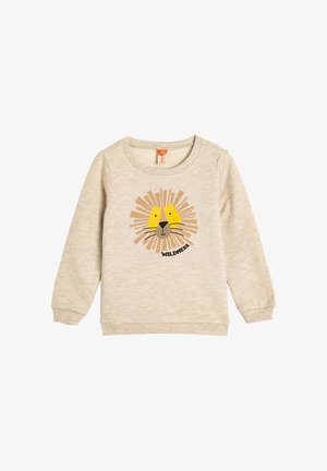 Sudadera de color beige claro hecha de material suave, con un gráfico de cara de león con acentos amarillos y el texto "WILDNESS" debajo.