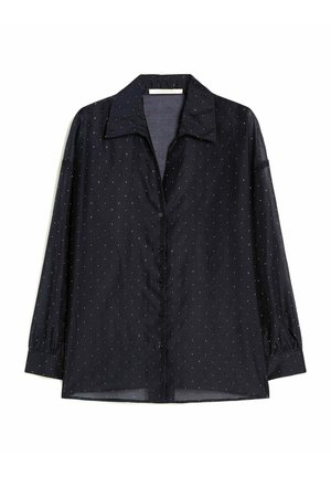 Chemise noire à manches longues avec petits pois blancs, col classique et manches à poignets, présentée sur fond blanc.