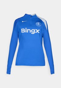 Blå langærmet atletisk top med kvart lynlås, Nike-logo på skulderen og "Bingx" sponsorskab i hvid, med en tætsiddende design.