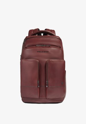 Bordeauxroter Lederrucksack mit zwei vorderen Reißverschlusstaschen, gepolsterten Trägern und oberem Griff. Glatte Textur mit dezenten Nahtakzenten.