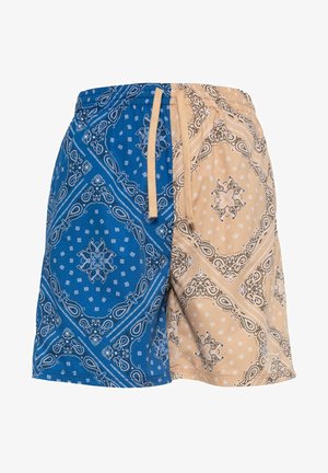 Šorti ar zilu un bēša bandanas rakstu, ar auklu jostu un kontrastējošiem sarežģītiem rakstiem katrā pusē.