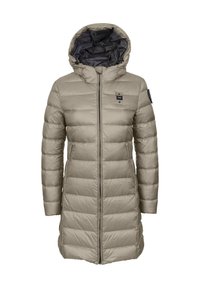 Beige puffer-takki huppulla, jossa on pystysuorat saumat ja vetoketjukiinnitys. Sisäpuoli on tumma, ja yhdessä hihassa on logo-yksityiskohta.