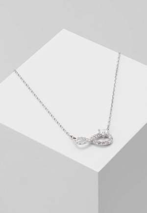 Delicate silver chain necklace with an infinity-shaped pendant adorned with small clear gemstones and a single heart-shaped stone.