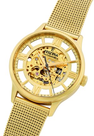 Goldene Automatikuhr mit transparentem Ziffernblatt, das das Uhrwerk zeigt. Das Design wird durch ein Netzarmband und römische Ziffern hervorgehoben. Sapphirglas.