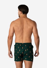 Groene boxers met een patroon van kleine peperkoekenmannetjes met hoedjes. Gemaakt van ademend materiaal, ontworpen met een elastische tailleband.