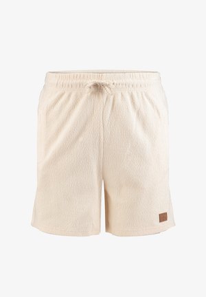 Pantalones cortos de tela texturizada beige con cintura elástica y cordón, con un pequeño parche cuadrado marrón con logo en la parte inferior de la pierna izquierda.