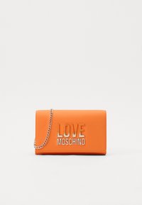 Orange clutch bag with a smooth faux leather finish, featuring a silver chain strap and embossed "LOVE MOSCHINO" logo on the front.