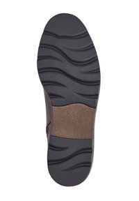 Semelle en caoutchouc noir avec un motif de semelle ondulé, semelle intérieure rembourrée marron avec empreinte de logo, design à bords incurvés pour le confort et la stabilité.