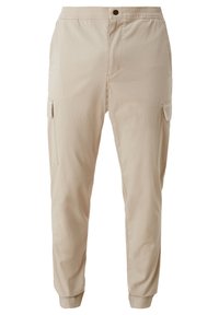 Pantalon cargo beige avec taille élastique, fermeture par bouton, poches à rabat latérales et poignets élastiques aux chevilles.