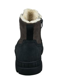 Brune og sorte ankelstøvler med foret inderside af pels, en tekstureret overdel og en sort gummisål, med lynlås og en trækkeøje.