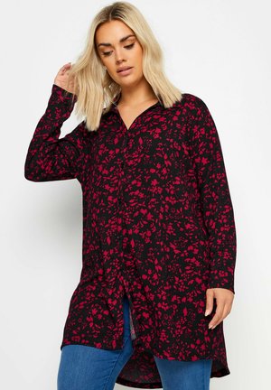 Black button-up blouse with red floral pattern, long sleeves, and a slightly curved hem. Features a collar and textured fabric.