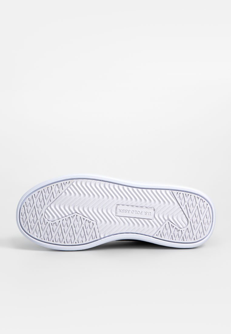 Semelle d'une sneaker, en caoutchouc texturé blanc avec un motif en zigzag, forme arrondie et logo imprimé au centre. Bords lisses.