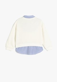 Felpa bianca con orlo e colletto a righe blu e bianche. Presenta polsini a costine e una vestibilità rilassata.