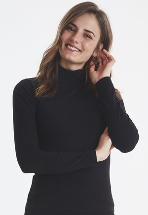Black long-sleeve turtleneck top made of stretchy material, featuring a fitted design and soft texture, suitable for layering.