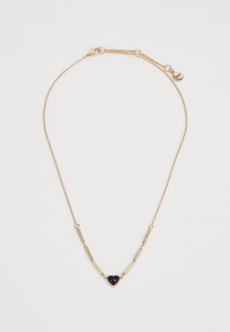 Colar de corrente de ouro delicado com elos em forma de tubo e um pendente central em forma de coração preto, apresentando um pequeno encantinho de marca perto do fecho.