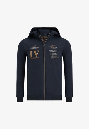 Felpa con zip color navy realizzata in un tessuto morbido, con grafiche e dettagli dorati. Comprende un cappuccio, tasche a marsupio e polsini e orlo a coste.