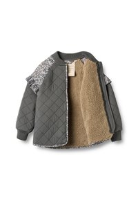 Pikowana zielona kurtka z rękawami w kwiatowy wzór, beżową podszewką z polaru i ściągaczami na rękawach. Otwarta z przodu, odsłaniająca ciepłą, miękką wyściółkę.